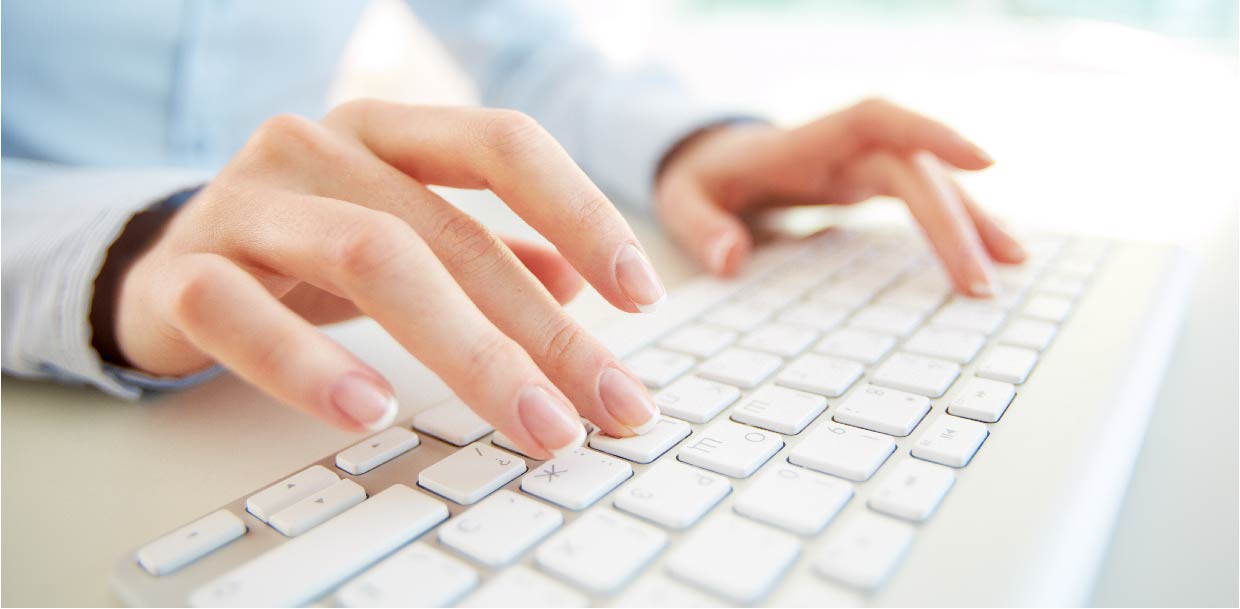 Photo of hands typing on a keyboard, illustrating the integration of test content and the creation of questions